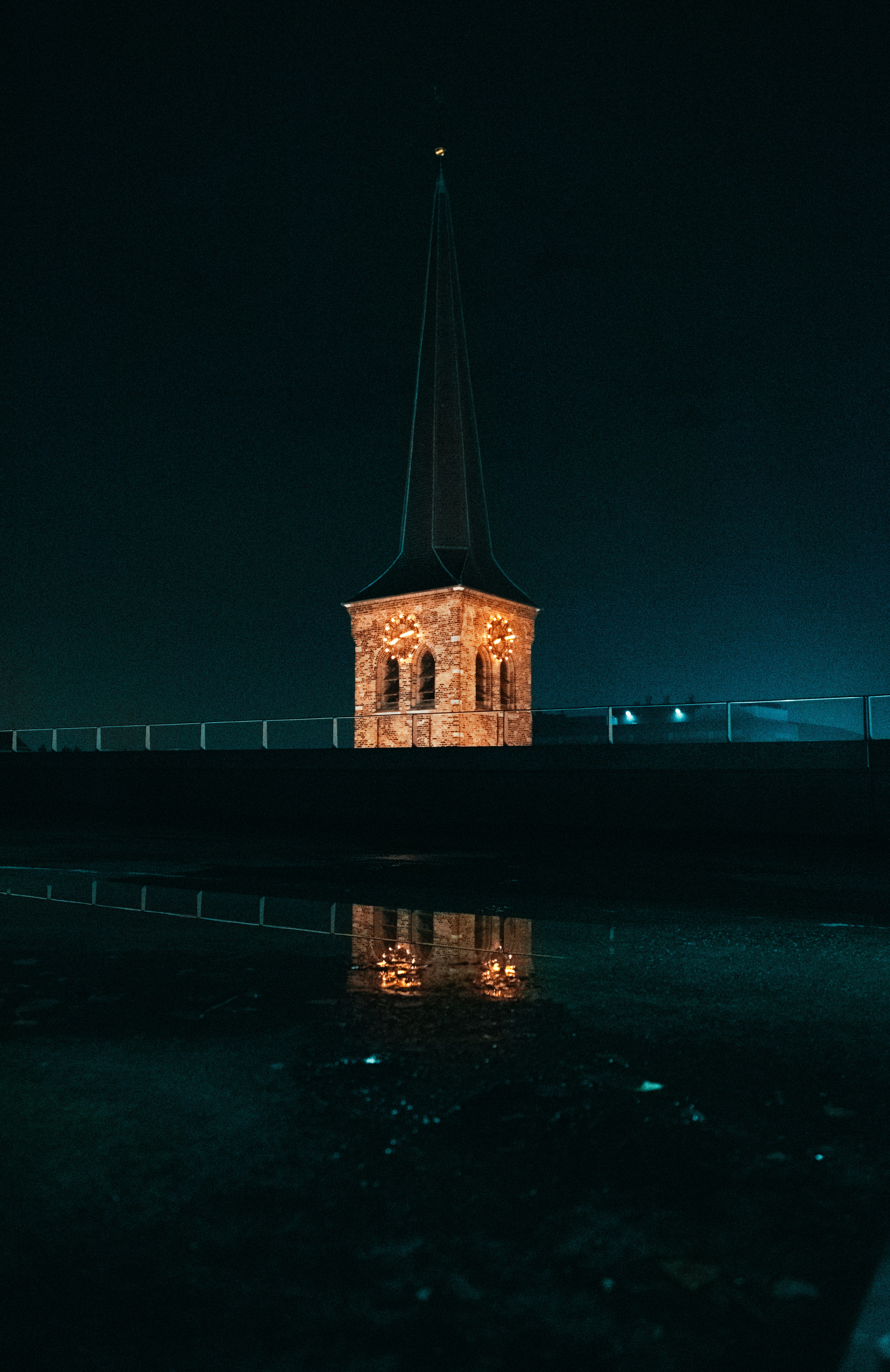 brown concrete building near body of water during night time